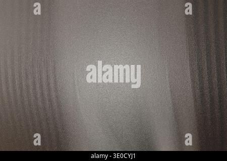 An image featuring a blurred abstract background with vertical streaks of dark grey and lighter grey, creating a textured effect. The overall tone is Stock Photo