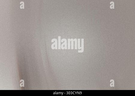 The image shows a detailed close-up view of a light gray fabric with subtle wrinkles and a slightly blurred texture. The overall tone is muted and sof Stock Photo