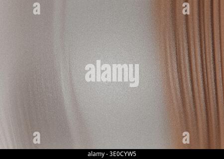 A detailed close-up shot reveals the texture of a fabric with a distinct two-tone color scheme. One half is off-white, while the other half is a light Stock Photo