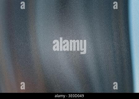An abstract image featuring a blurred vertical texture with varying shades of gray and blue, creating a soft and hazy effect. The image lacks sharp de Stock Photo