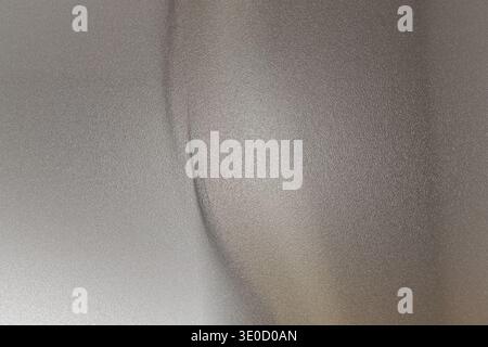 A detailed image shows a thin, vertical crack in a light gray wall. The crack is subtle and appears to be in a smooth, possibly plastered surface. The Stock Photo