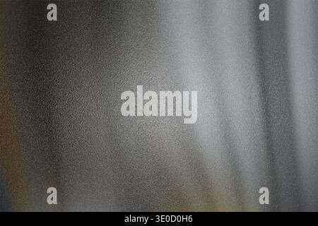 An image featuring a blurred background with vertical stripes of varying shades of gray and white. The effect creates a soft, abstract texture. Stock Photo