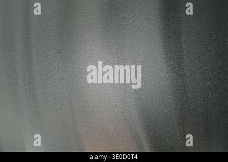 The image shows an out-of-focus background with vertical stripes of varying shades of gray and white. The texture is soft and the overall impression i Stock Photo