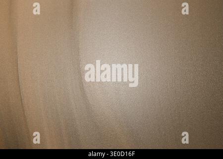 The image shows a detailed close-up view of a light brown fabric with a subtle texture. The lighting is soft and even, highlighting the material's sub Stock Photo
