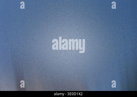 A softly blurred image featuring a gradient of blue and gray tones. The texture is subtle and slightly mottled, creating a calming and understated vis Stock Photo