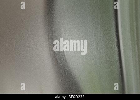 The image shows a blurred close-up view of two distinct surfaces, one lighter and one darker, with a subtle curve separating them. The textures are sm Stock Photo