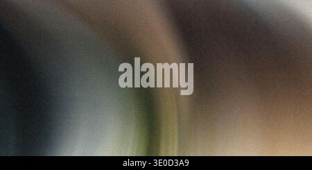 This image showcases a smooth, blurred gradient transitioning from dark teal to muted browns and tans. The effect is abstract and evokes a sense of ca Stock Photo