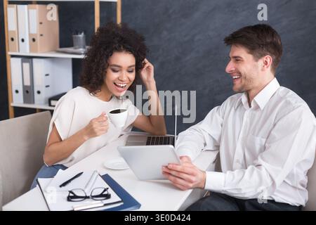 Businesspeople using digital tablet and drinking coffee Stock Photo
