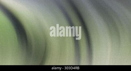 A blurred image featuring a blend of green and gray tones in a swirling, motion-blurred pattern. The effect creates an abstract and dynamic visual. Stock Photo