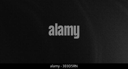 A blurry monochrome image featuring a dark gradient, transitioning from black to a slightly lighter shade. The texture is subtle and undefined. Stock Photo