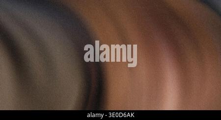 An abstract image featuring a blurred blend of brown and gray hues creating a smooth, indistinct texture. Stock Photo