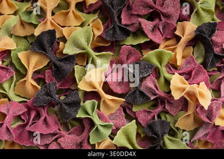 Mixture of colorful farfalle pasta background Stock Photo
