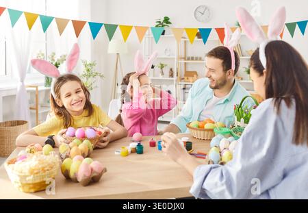 Happy family gather together for decorating Easter eggs at home  Stock Photo