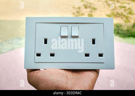 Double 3-pin British standard wall socket with integrated switches, 13A UK Standard Type G Twin Wall Socket Stock Photo