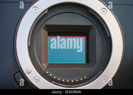 Close up shot of APS-C (Crop Sensor) CMOS sensor in mirrorless camera with metallic mount and lens contact points Stock Photo