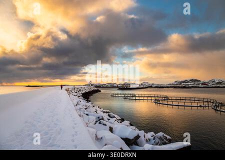 Sunrise view over the pier of Ballstad in the morning after a snowfall. Ballstad, Vestvagoy, Lofoten Islands, Nordland, Norway, Scandinavia. Stock Photo