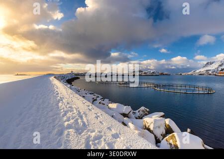 Sunrise view over the pier of Ballstad in the morning after a snowfall. Ballstad, Vestvagoy, Lofoten Islands, Nordland, Norway, Scandinavia. Stock Photo