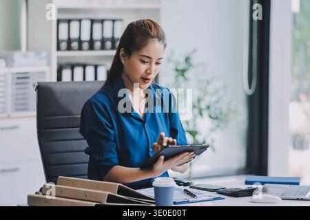 Young Asian businesswoman giving presentation Stock Photo