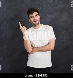 Man pointing up, making idea gesture Stock Photo