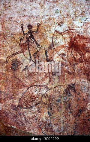 Aboriginal rock art depicts figures of Mimi Spirits on a cave wall ...