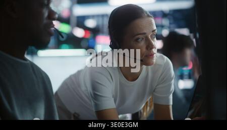 Diverse Team Traders Discussing Urgent Market Strategy During Volatility. Male Trader and Female Colleague Intensely Collaborate in Futuristic Financial Hub. Concept Collaborative Crisis Management. Stock Photo