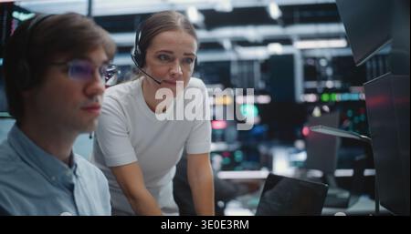 Male and Female Brokers Analyzing Real Time Stock Data Together. Two Professional Investment Experts Collaborate Closely on Trading Floor. Strategy Discussion, Data Driven Decision Making, Teamwork. Stock Photo