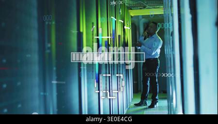 Holding handset, tech in white shirt inspecting server racks in datacenter with HUD, copy space Stock Photo