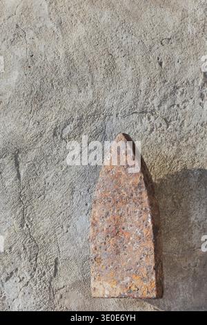 Old cast-iron flatiron soleplate with heavy rust texture, antique ironing tool. Stock Photo