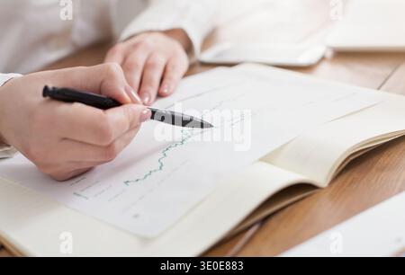 Business woman analyzing marketing graphics Stock Photo