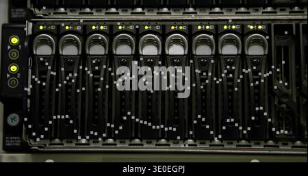 Showing rack server drive bay in data center, featuring hot-swap caddies and yellow LEDs Stock Photo