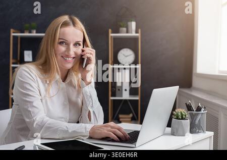 Young businesswoman having business call in office Stock Photo