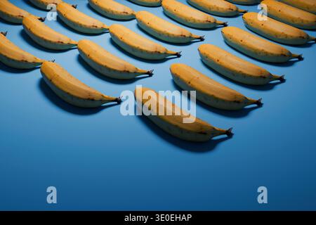 A creative pattern of ripe yellow bananas arranged in a repetitive grid on a solid blue background. High-quality 3D render with realistic textures, so Stock Photo