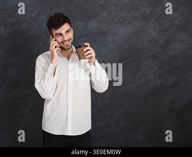 Excited man having pleasant conversation on smartphone Stock Photo