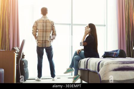Woman and man in hotel room on vacation Stock Photo