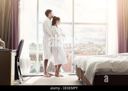 Young happy couple in hotel room in the morning Stock Photo