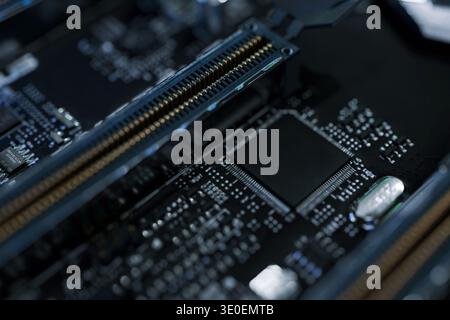 Macro shot of high-performance DDR RAM modules and PCIe slots on a modern motherboard. Professional PC hardware components with brushed metal heat sin Stock Photo