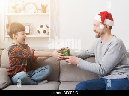 Father giving his son a christmas present at home Stock Photo