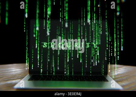 laptop displaying the word SECURITY formed by glowing green binary code. Features digital rain falling against a dark background. themes of data prote Stock Photo