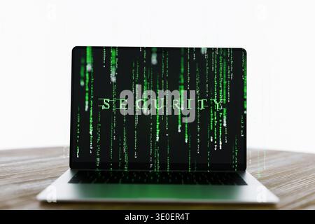 laptop displays the word SECURITY formed by glowing green matrix-style code. Features digital rain effects against various backgrounds, symbolizing en Stock Photo