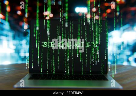 laptop screen displaying the word SECURITY formed by glowing green matrix-style code. Features digital rain effects, representing data encryption, cyb Stock Photo