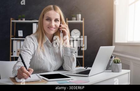 Young manager working at her desk in the office Stock Photo