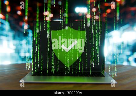 laptop screen displaying a green shield with a checkmark over digital matrix rain, representing successful cybersecurity, verified data protection, sy Stock Photo