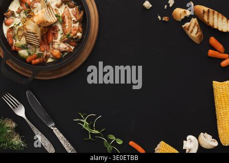 Meat and vegetable ragout on black table, top view Stock Photo