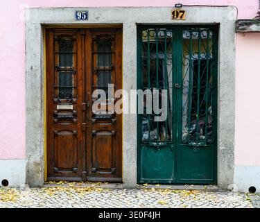 A pair of colorful doors to an old, residential building in the historic Alfama neighborhood of Lisbon, Portugal. Stock Photo