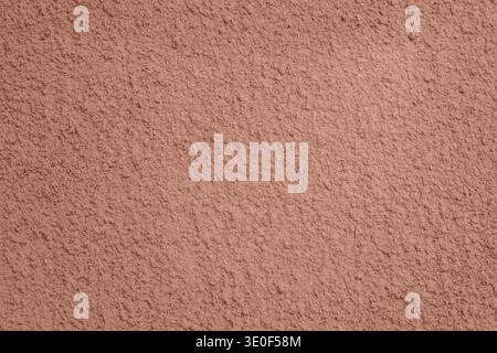 Rough pink stucco wall texture background with plaster finish and subtle shadow Stock Photo