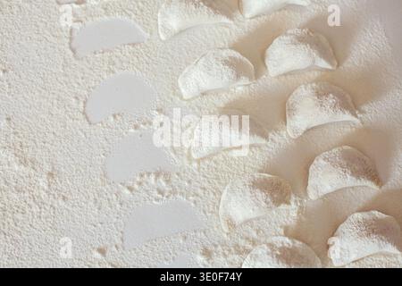Raw handmade vareniki on table sprinkled with flour Stock Photo