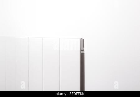Minimal white interior detail with modern til backsplash against smooth off-white painted wall. Clean geometric lines, hard drop light and shadow, and Stock Photo