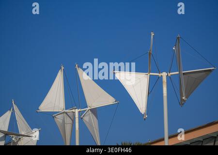 Sail shade structures, Porto Antico di Genova, Genoa, Italy. Modern tensile architecture against clear blue sky near entertainment hub. Stock Photo
