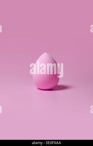 Pink makeup sponge on pastel pink background Stock Photo