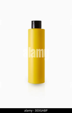 Yellow cosmetic bottle isolated on gray background Stock Photo